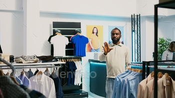 African american shopper using hologram in boutique