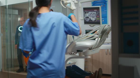 Stomatologist Performing Examination and Taking Care of Teeth