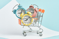 Three alarm clocks of different colors in a shopping cart. - PhotoDune Item for Sale