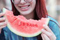Girl eating a slice of ripe red watermelon, close-up. - PhotoDune Item for Sale