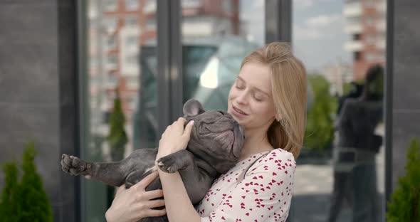 Beautiful Young Girl Holding Adorable French Bulldog Puppy