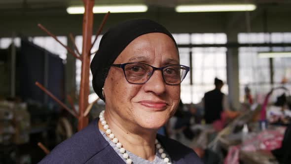 Mixed race woman working at a hat factory