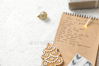 Cookie, gift boxes and notepad with list on white background, space for text