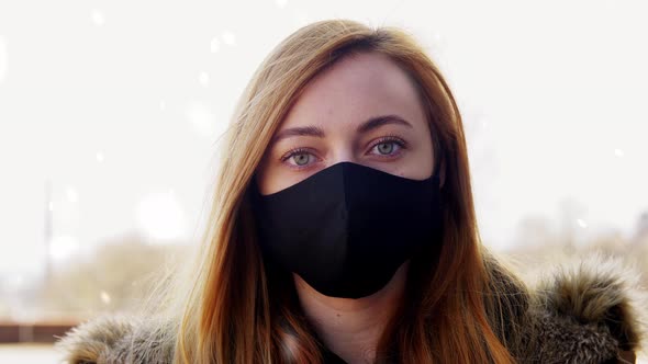 Woman Wearing Reusable Protective Mask in Winter