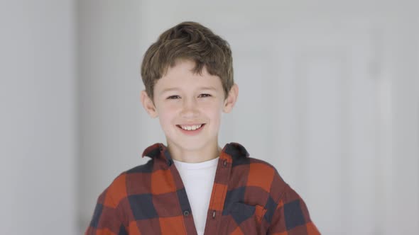 Cute little boy laughing at camera