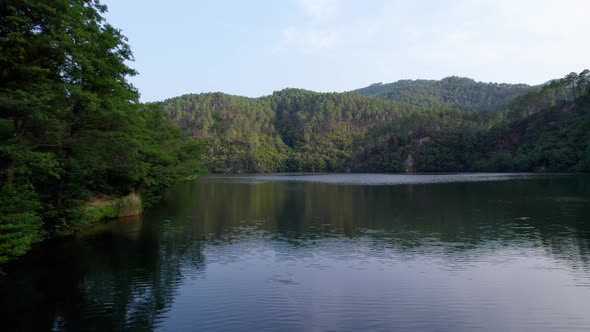 Calm waters of lake Cambous in Branoux-les-Taillades France, Aerial low angle shot