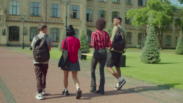 Rear View of Diverse Multiethnic Students Walking at University Campus