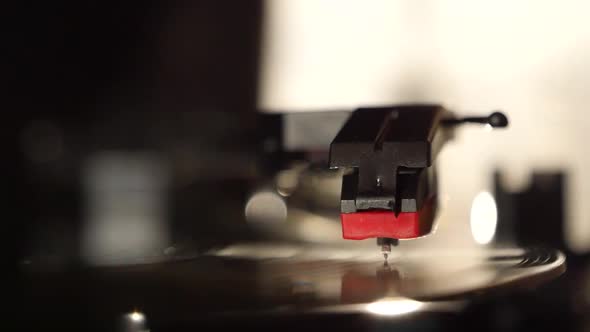 Turntable vinyl record player, man puts a vinyl record and includes a gramophone