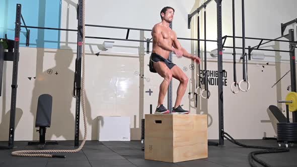 Slowmotion Full Shot of a Fit Young Caucasian Sportsman Training Alone Doing Box Jump Exercise in