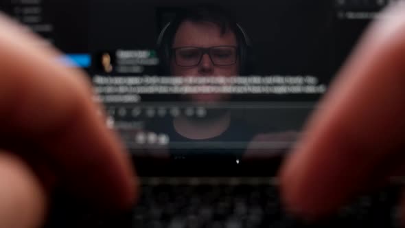 Man Face Reflection in Laptop Screen Working on PC