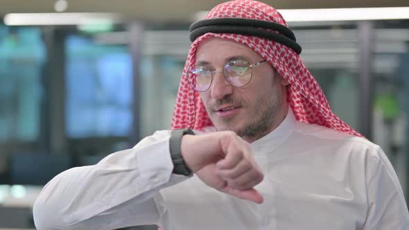 Middle Aged Arab Man attending Call on Smartwatch