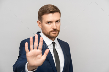 Man businessman gestures to stop. Business guy shows open palm meaning stop enough urging to avast.