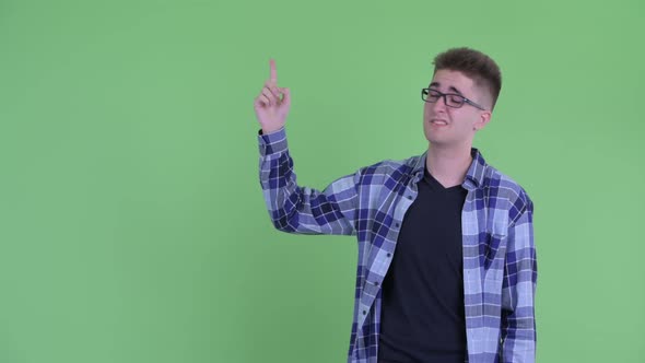 Stressed Young Hipster Man Pointing Up and Looking Upset