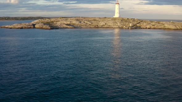 Tranquil Scenery Of The Sea And Lille Torungen Lighthouse In Arendal, Norway - aerial drone shot