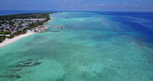 Natural flying abstract view of a white sand paradise beach and blue ocean background in vibrant 4K