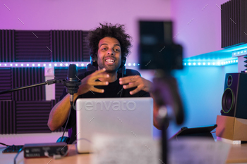Vlogger recording a video tutorial in a music studio