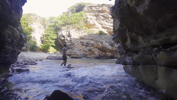 The young man is walking in the Sea Canyon.