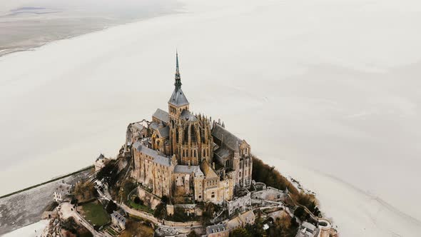 Drone Zooming Out, Flying Up and Away From Mont Saint Michel Epic Island Abbey Landmark During Low