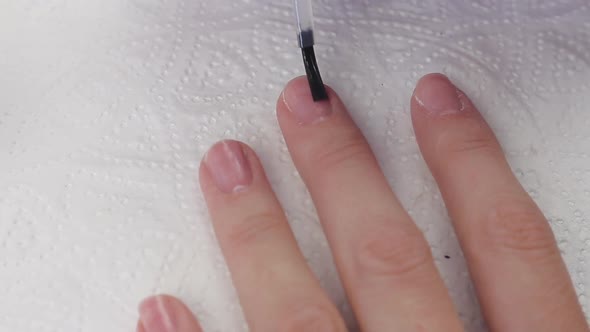 Young Woman Applying Based Primer Dehydrator Bond To Nails To Help Promote Adhesion. Nails Manicure