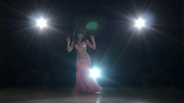 Beautiful Exotic Belly Dancer Woman Dancing on Black, Back Light