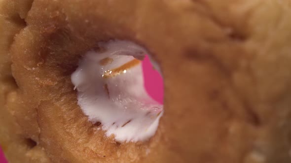 Super Macro Footage of Donut Close Up Center Hole Rotate on Pink Background. Delicious Tasty Junk