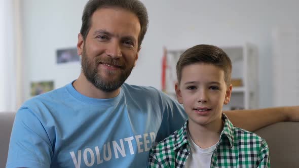 Man and Boy Posing for Camera, Volunteer Visiting Little Kid in Orphan, Adoption