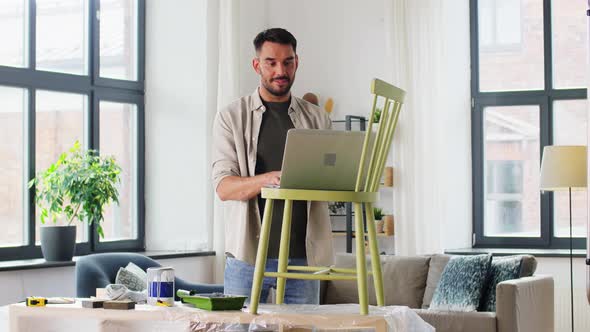 Man with Laptop Preparing Old Chair for Renovation
