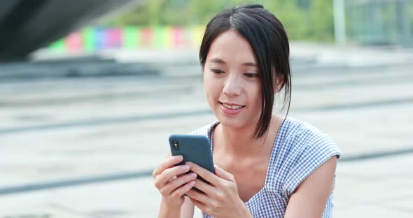 Woman use of mobile phone in city