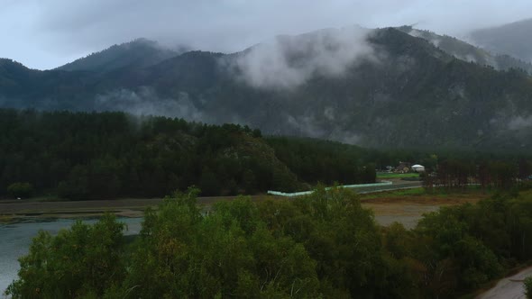 mountains and forest in the clouds view from above