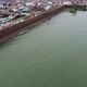 Drone View of the Sea Coast Near the Pier with the Town in the Background - VideoHive Item for Sale