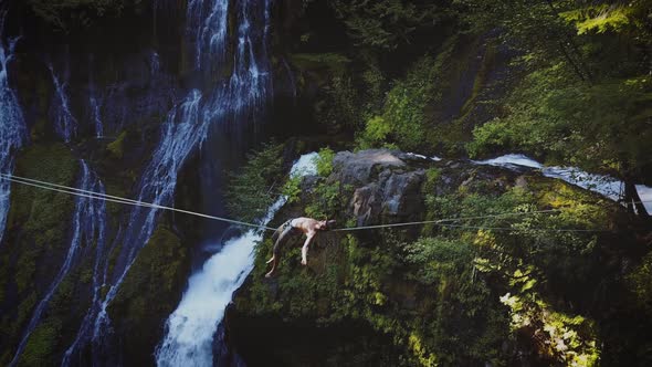 Fit Man High-lining Over A Waterfall