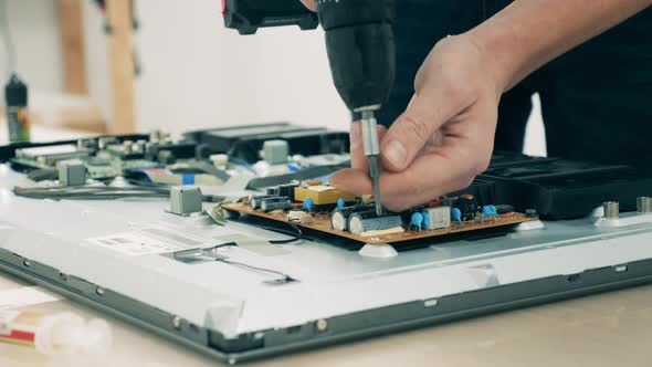 Electronic Device is Getting Dismantled By a Repairman
