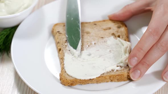 Woman Makes Vegetarian Toast with Soy Cheese