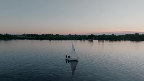 Yacht Sailing Down the River During Beautiful Sunset