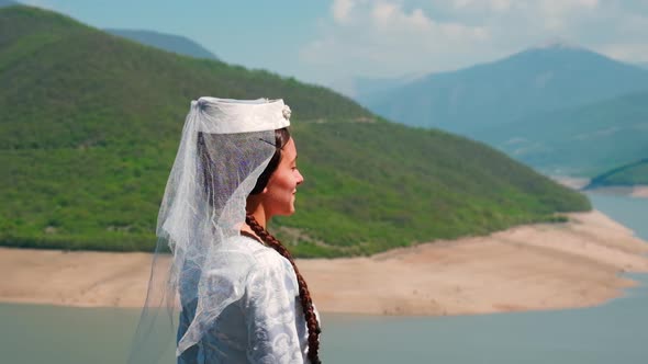 A Girl in a Georgian National White Dress is Dancing