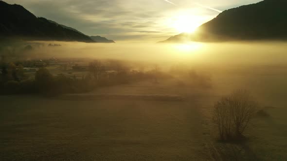 Flying over autumn landscape at sunrise