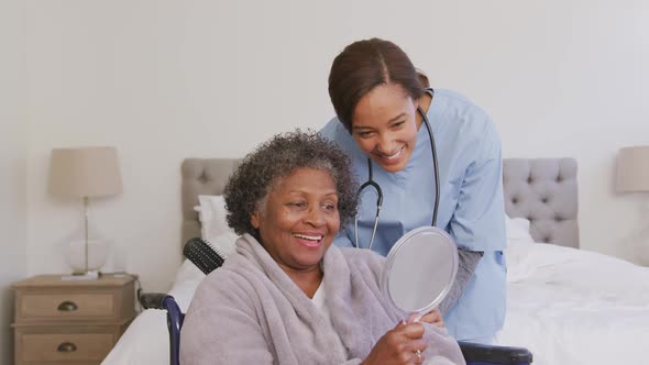 Mixed race woman being visited at home by a nurse. Social distancing and self isolation in quarantin