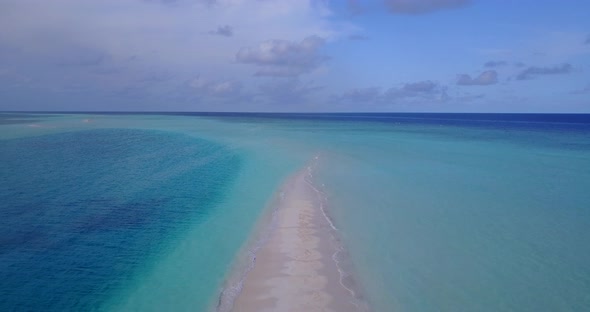 Tropical aerial abstract shot of a sandy white paradise beach and aqua turquoise water background in