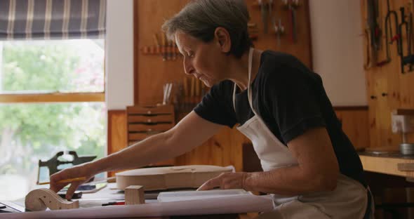 Female luthier at work in her workshop