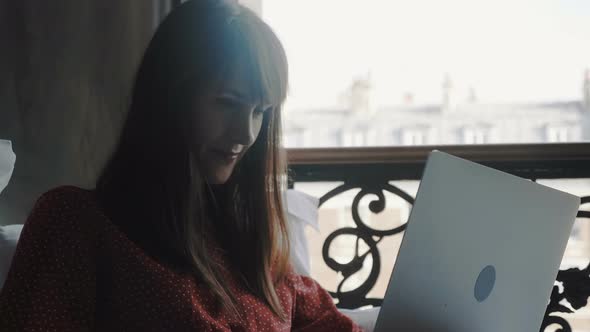 Freelance Work Concept, Happy Beautiful Smiling Caucasian Writer Woman Using Laptop in Bed