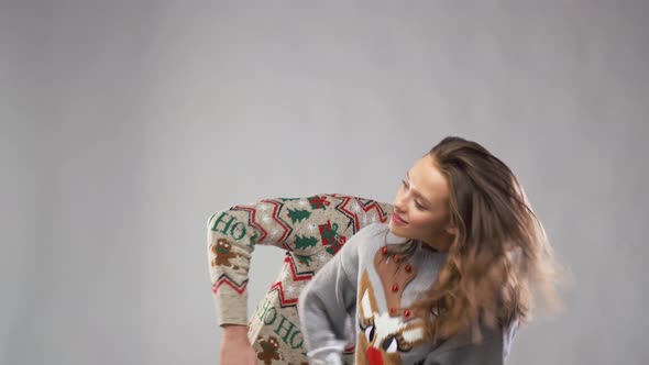 Happy Couple in Christmas Ugly Sweaters Dancing 28