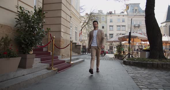 Man Walks Near The Hotel In The City Center