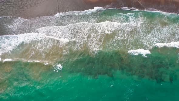 Aerial View of the Mediterranean Coast Waves Reach the Deserted Sandy Beach