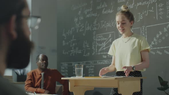 Girl Speaking at Lectern during High School Class