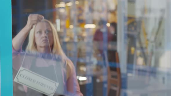 Sad Mature Small Business Owner Hang Closed Forever Sign on Glass Door