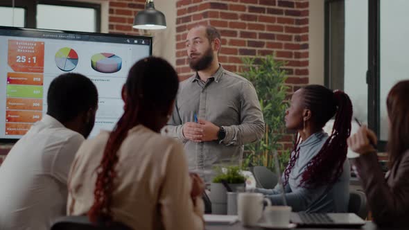 Business Man Presenting Financial Analysis on Monitor