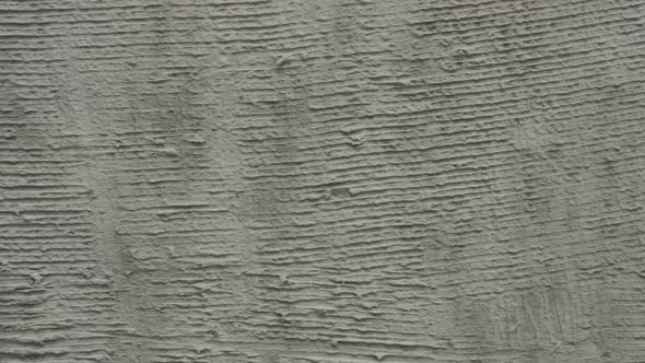 Background of a Moving Wall Prepared in Putty in Gray Concrete