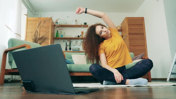 Gorgeous Lady Is Stretching During Training at Home. COVID-19 Lockdown Concept.