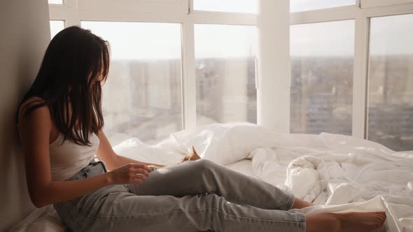 Asian Woman With Kitten Indoors