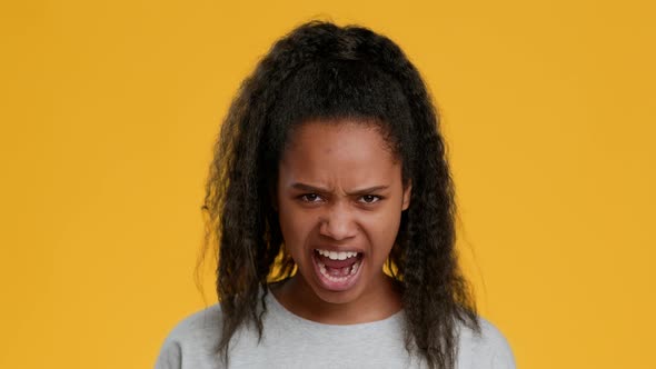 Angry Black Teenager Girl Shouting Posing Over Yellow Background